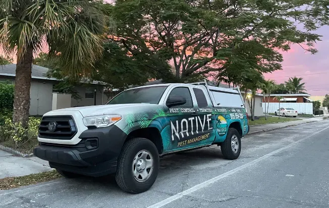 A native pest truck parked in front of a customer's home